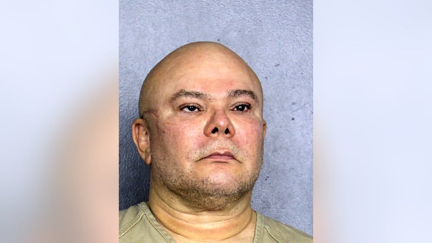 Jorge hernandez pictured in a mugshot, bald with stubble, her has a scar on the right side of his face and a lazy eye