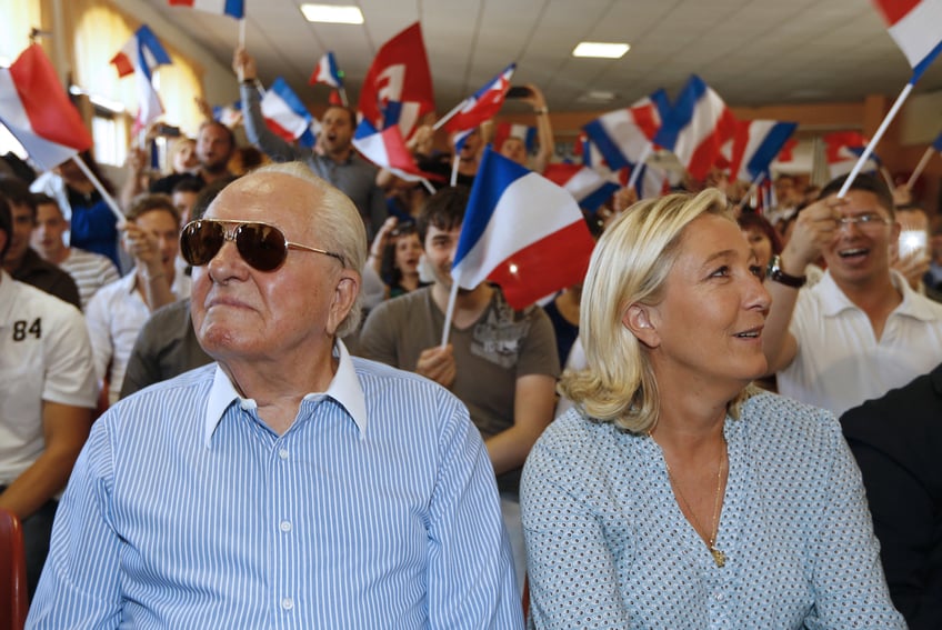 French far-right leader Marine Le Pen (R) and her father French former leader and founder of the French far-right party Front national (FN) Jean-Marie Le Pen attend a youth summer congress of the Front National (FN) far-right party, in Frejus, southern France, on September 7, 2014. (Photo by Valery HACHE / AFP) (Photo by VALERY HACHE/AFP via Getty Images)