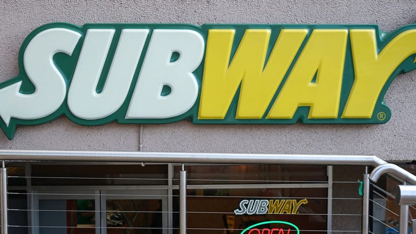 Subway restaurant entrance exterior. Subway is an American fast food restaurant franchise that sells submarine sandwiches and salads.