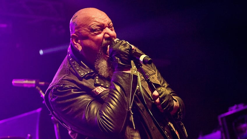 Paul Di'Anno singing into microphone