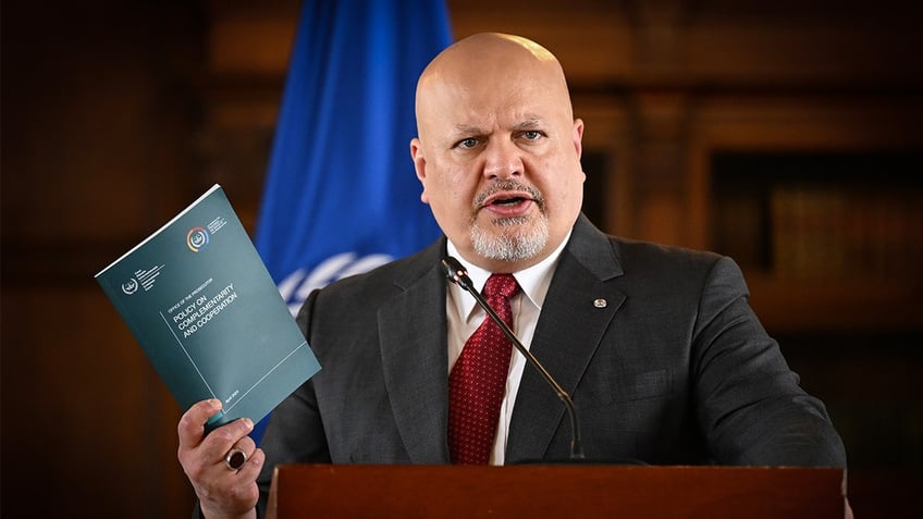 Karim Khan speaking at a microphone