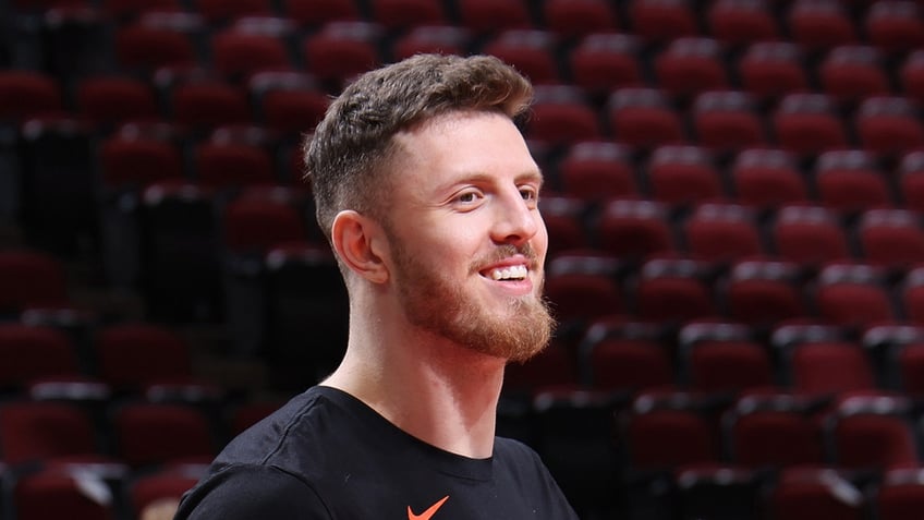 Isaiah Hartenstein smiles before a game