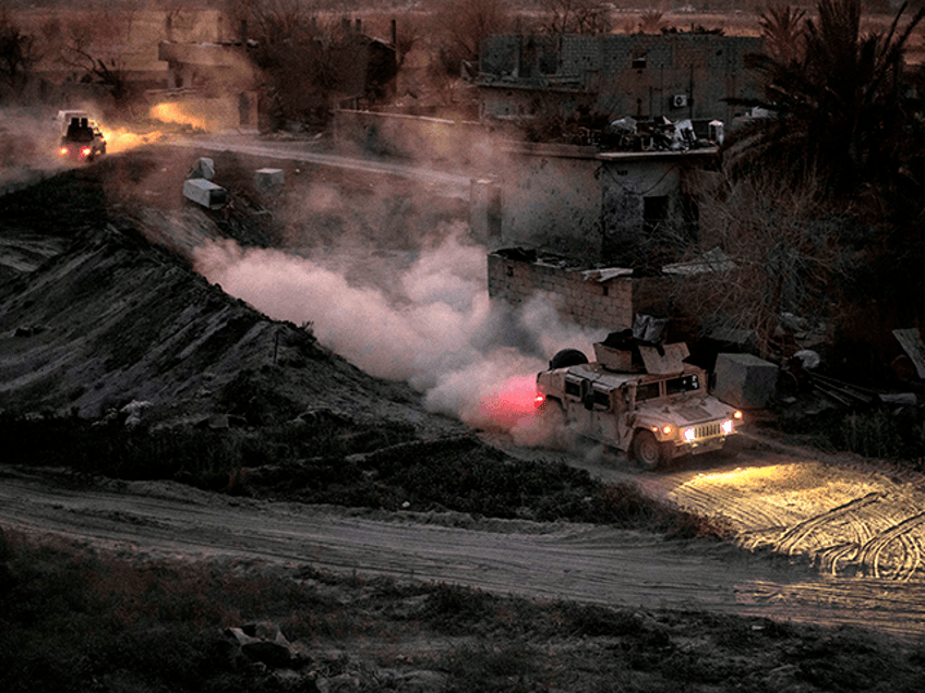 A general view shows a vehicle of the Kurdish-led Syrian Democratic Forces (SDF) in the village of Baghouz, near Syria's border with Iraq, in the eastern Deir Ezzor province on March 11, 2019, as their battle continues against the last pocket of Islamic State group (IS) jihadists. - Baghouz is the latest major battlefront in Syria's complex civil war, which has killed more than 360,000 people since 2011. Beyond it, the Islamic State group retains a presence in eastern Syria's vast Badia desert and sleeper cells in the northeast. (Photo by Delil souleiman / AFP) (Photo credit should read DELIL SOULEIMAN/AFP via Getty Images)