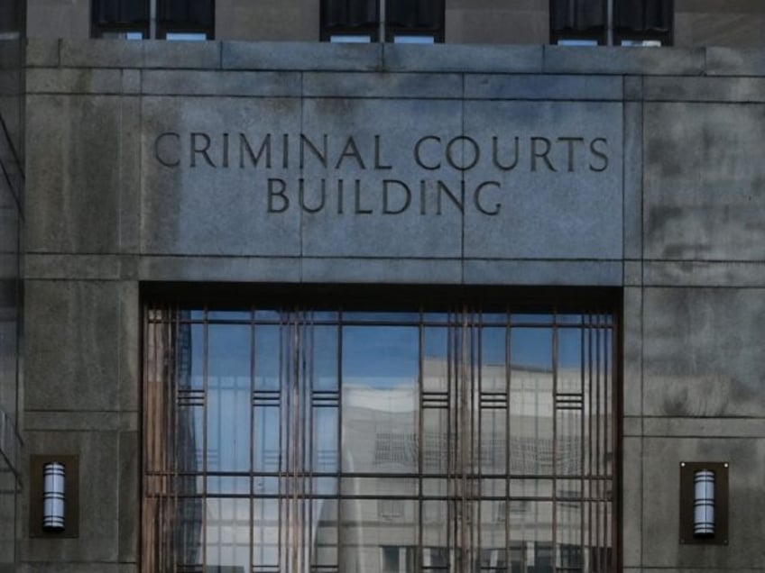 People walk past the Criminal Courts building and District Attorneys office in Manhattan,w