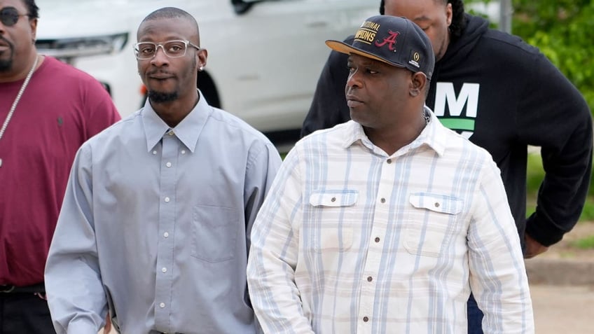 Michael Corey Jenkins, left, and Eddie Terrell Parker walk toward the Thad Cochran United States Courthouse in Jackson