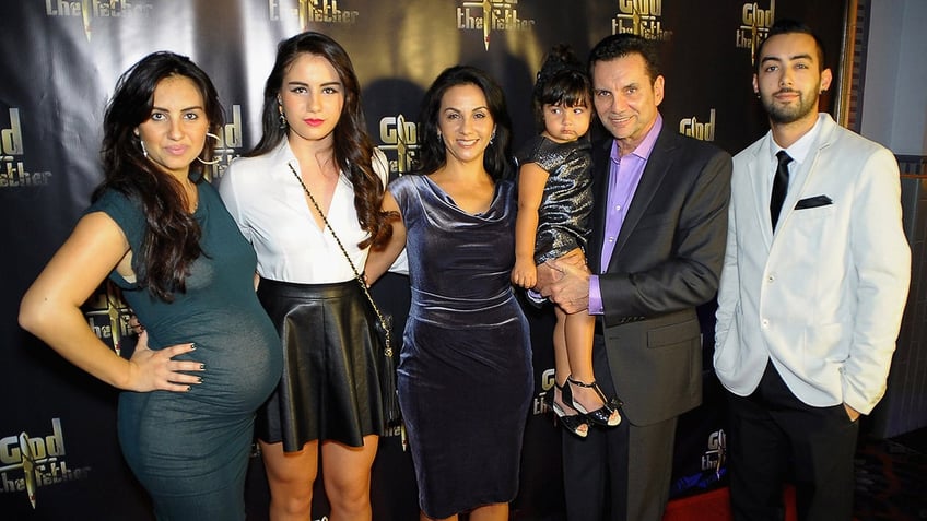 Michael Franzese with his family smiling on the red carpet.