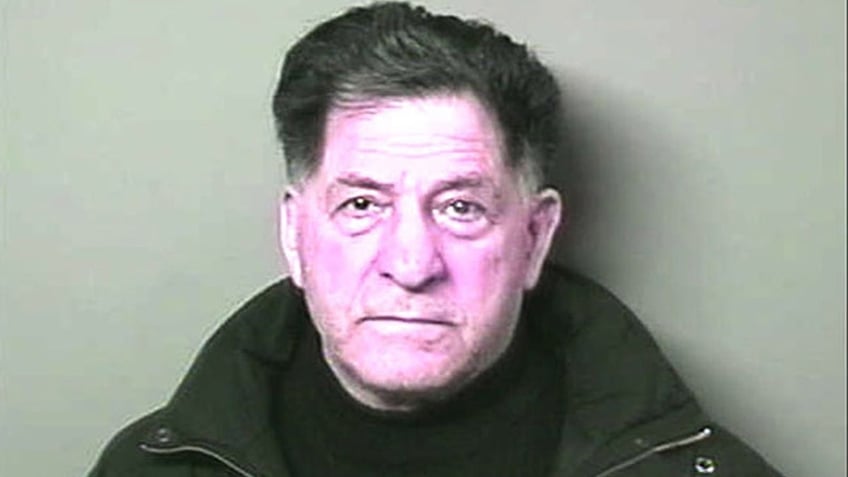 A mugshot of Sonny Franzese wearing black