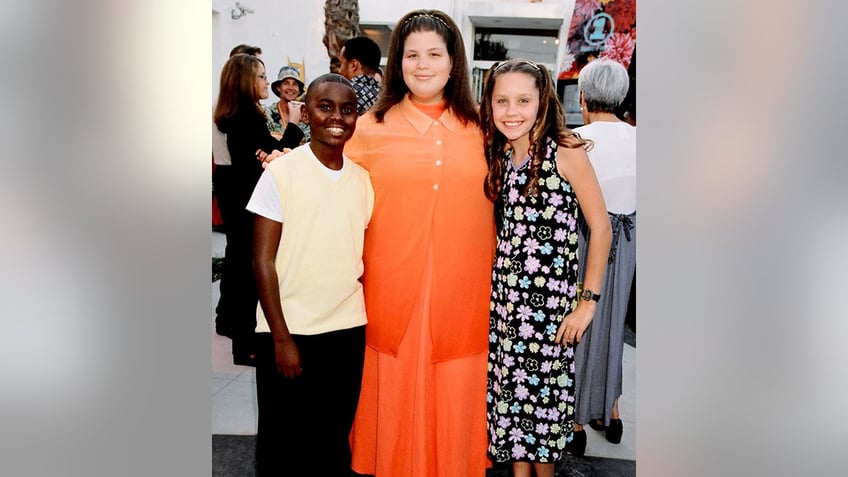 Lori Beth Denberg poses between a black boy and Amanda Bynes