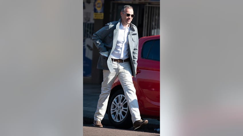 Oscar Pistorius walks to his car
