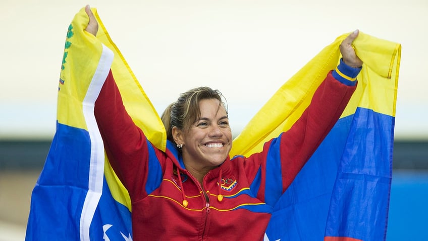 Daniela Larreal waves a flag