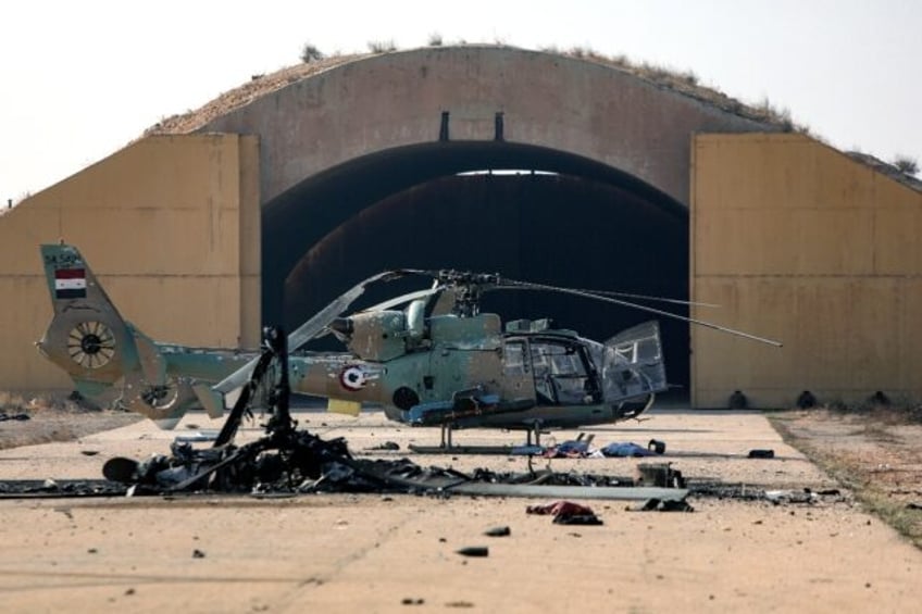 A burned-out helicopter at the Mazzeh air base outside Damascus following Israeli air stri