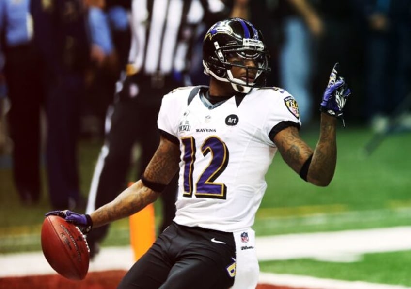 Jacoby Jones reacts after scoring on a 108-yard kick-off return for the Baltimore Ravens i