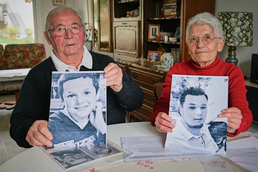 Roland and Mauricette Vinet show photographs of their grandson Mathis, a victim of French retired surgeon Joel Le Scouarnec when he was 10, in Saint-Germain, western France, on February 3, 2025. Their grandson, Mathis, is one of about 300 victims who were sexually assaulted or raped by the former surgeon Joel Le Scouarnec. He died of an overdose in 2021. Roland and Mauricette Vinet consider themselves "collateral victims" and will attend the trial "to honor his memory". The former surgeon will be tried starting February 24, 2025 before the criminal court of Morbihan in Vannes for the rapes or sexual assaults of 299 former patients, most of whom were minors at the time of the events. (Photo by Guillaume SOUVANT / AFP) (Photo by GUILLAUME SOUVANT/AFP via Getty Images)