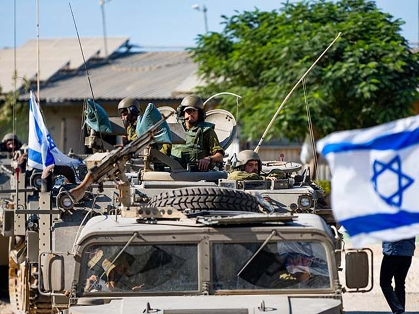 IDF Soldiers ride in armored personnel carriers on October 17, 2023 in Be'eri, Israel. As Israel prepares to invade the Gaza Strip in its campaign to vanquish Hamas, the Palestinian militant group Hamas who launched a deadly attack in southern Israel on October 7th, worries are growing of a wider …