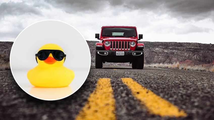 A rubber duck with sunglasses and a Jeep on the road in the background