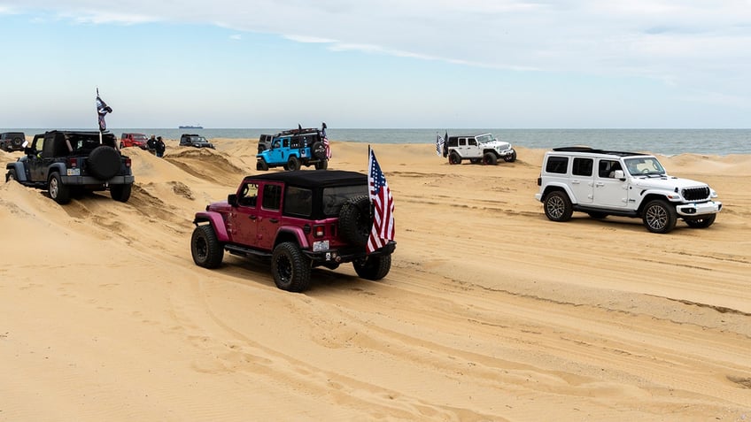 Jeeps driving in the sand