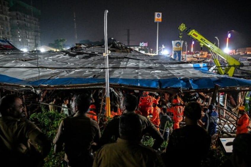 National Disaster Response Force (NDRF) personnel look for survivors during a rescue opera