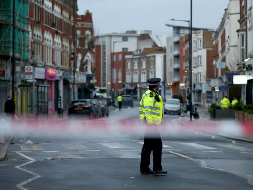 LONDON, ENGLAND - FEBRUARY 07: Metropolitan Police officers standing behind a police cordo