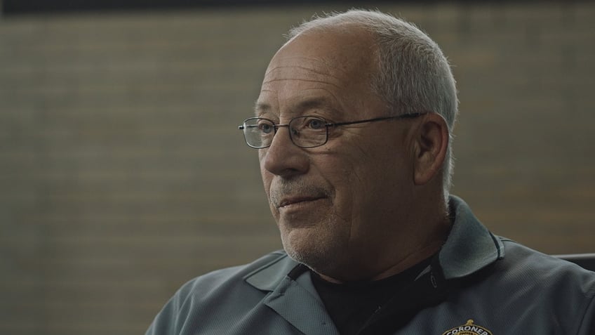 A close-up of Jeff Jellison looking to the side wearing a blue shirt.