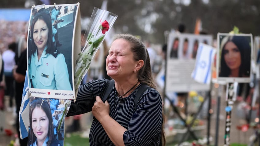 RE'IM, ISRAEL - OCTOBER 07: A woman breaks down at the memorial to Yulia Waxer Daunov as family members and friends of the lost and kidnapped gather at the site of the Nova Festival to mark the one year anniversary of the attacks by Hamas terrorists on October 07, 2024 in Re'im, Israel.