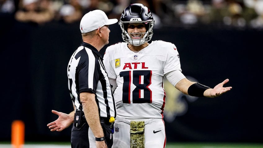 Kirk Cousins with a referee