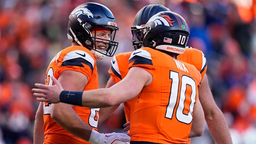 Adam Trautman celebrates with Bo Nix