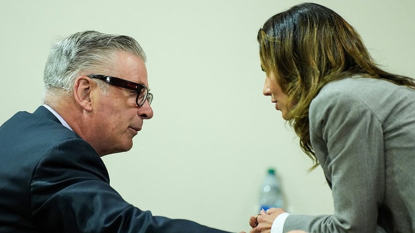 Alec Baldwin speaks with his wife Hilaria Baldwin during his trial