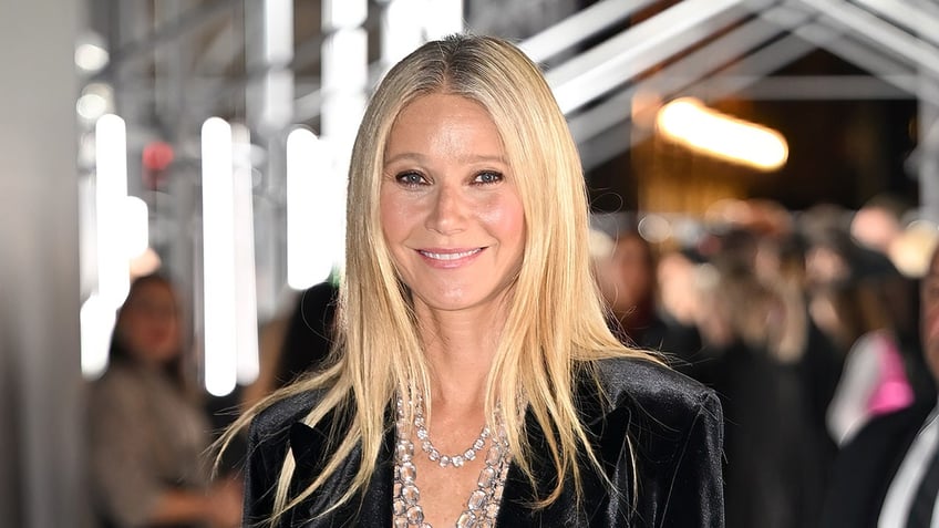 Actress Gwyneth Paltrow stays warm wearing black coat.