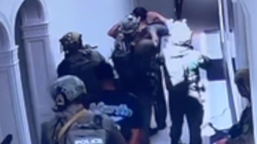 Tactical officers detain men inside Diddy's mansion