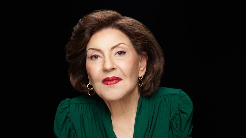 Kelly Bishop wearing a green dress.