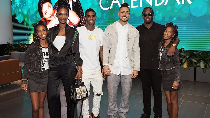 Kim Porter and Sean Combs pose with their children Quincy, Christian, Jessie and D'Lila at an event for Netflix