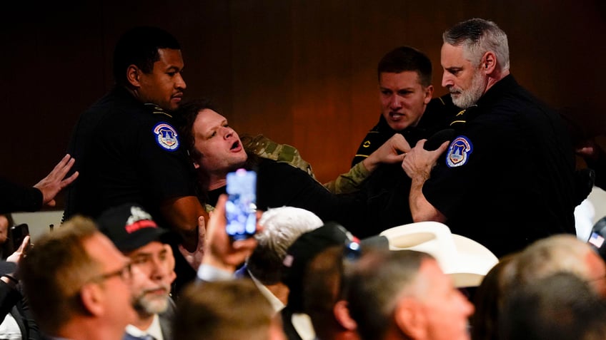 Protester at Hegseth hearing