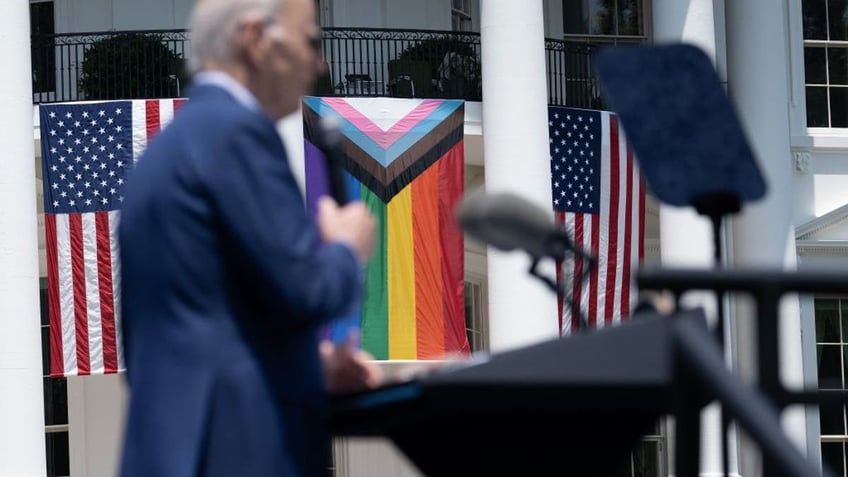 Biden with US, pride flags on White House in background