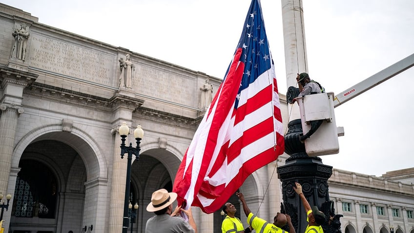 National Park Service workers put up US flag at Union Station