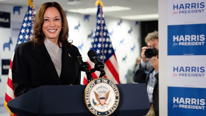 Kamala Harris at lectern at campaign HQ