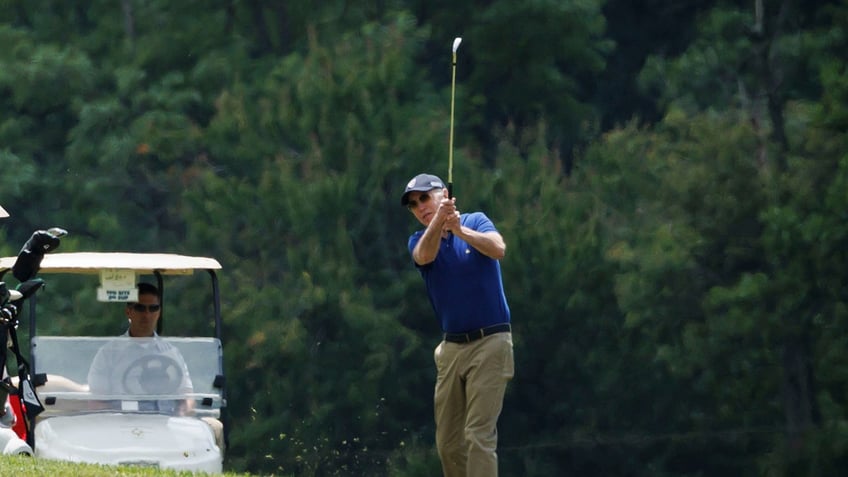 US President Joe Biden plays golf