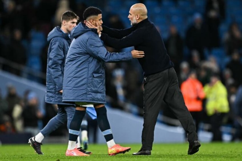 Pep Guardiola comforts his players after Manchester City's 4-0 loss to Tottenham