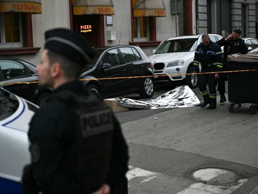 French municipal police officers operate to collect evidence at the site of a bladed weapo