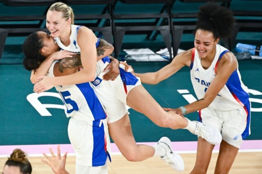 France's Gabby Williams and Marine Johannes celebrate their victory over Belgium in the Ol