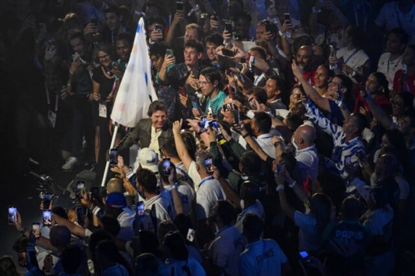 Hollywood star Tom Cruise abseiled into the stadium and made off with the Olympics flag on