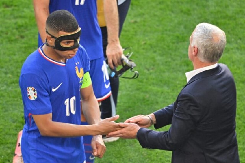 France coach Didier Deschamps shakes hands with Kylian Mbappe at the end of the 1-1 draw w