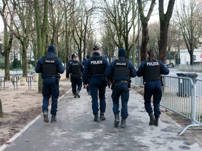 A group of police officers are walking in the street, Paris, on January 3, 2025. (Photo by