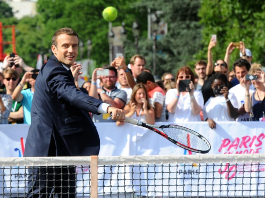 PARIS, FRANCE - JUNE 24: French President Emmanuel Macron plays tennis on Alexandre III bridge as Paris promotes its candidacy for the 2024 Summer Olympic and Paralympic Gameson June 24, 2017 in Paris, France. Paris transforms into a giant Olympic park to celebrate International Olympic Day with thirty sporting events …