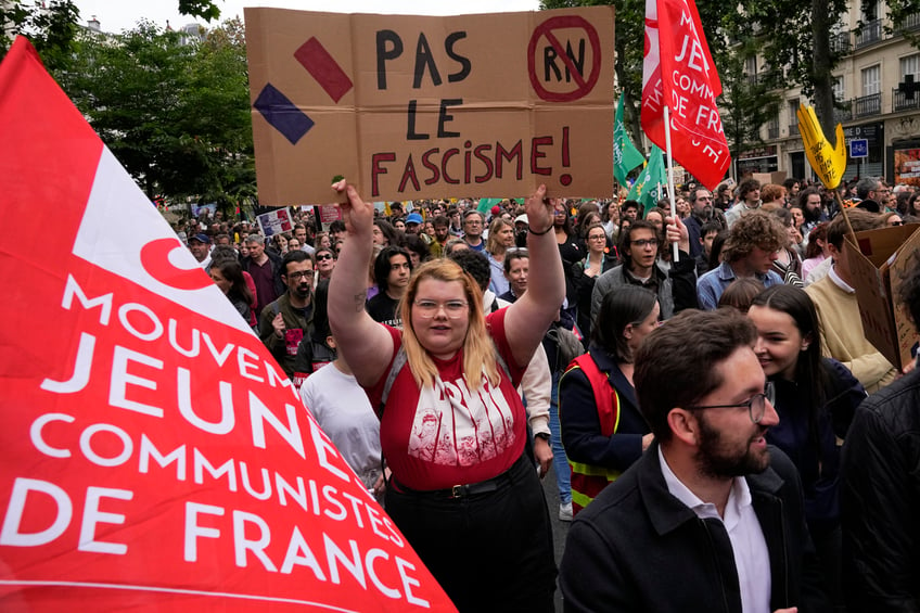 A protester holds an anti-far right banner during a rally in Paris, Saturday, June 15, 2024. Anti-racism groups joined French unions and a brand-new left-wing coalition in protests in Paris and across France on Saturday against the surging nationalist far right as frenzied campaigning is underway ahead of snap parliamentary elections. (AP Photo/Michel Euler)