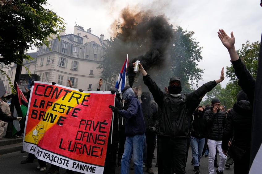 Protesters hold an anti-far right banner during a rally in Paris, Saturday, June 15, 2024. Anti-racism groups joined French unions and a brand-new left-wing coalition in protests in Paris and across France on Saturday against the surging nationalist far right as frenzied campaigning is underway ahead of snap parliamentary elections. (AP Photo/Michel Euler)