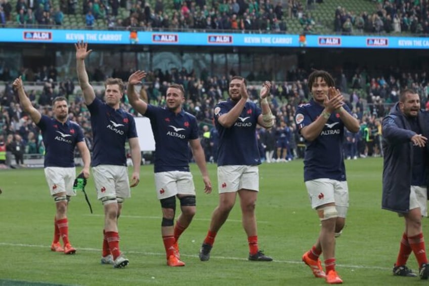 The France players celebrate on the field at Lansdowne Road after a stunning 42-27 win ove
