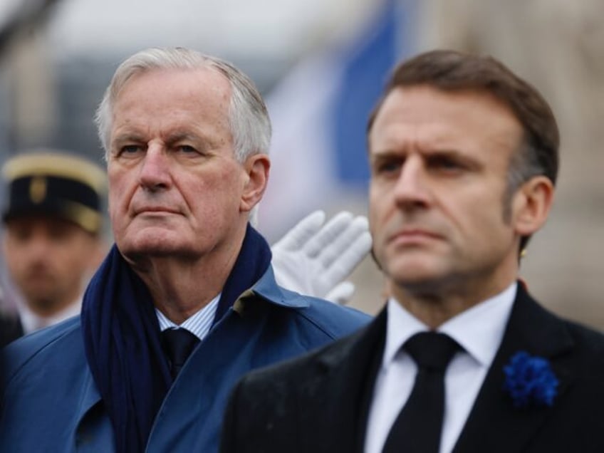 France's President Emmanuel Macron (R) and France's Prime Minister Michel Barnier stand at