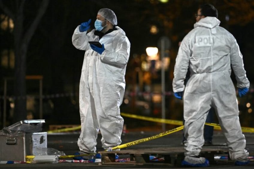 Forensics teams worked to gather evidence before the rain washed it away