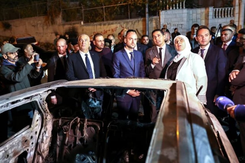 French Foreign Minister Jean-Noel Barrot (C) inspects cars torched in an attack by Israeli