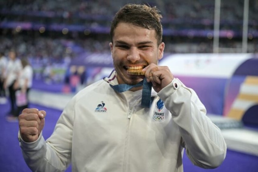 Antoine Dupont celebrates with his Olympic gold medal